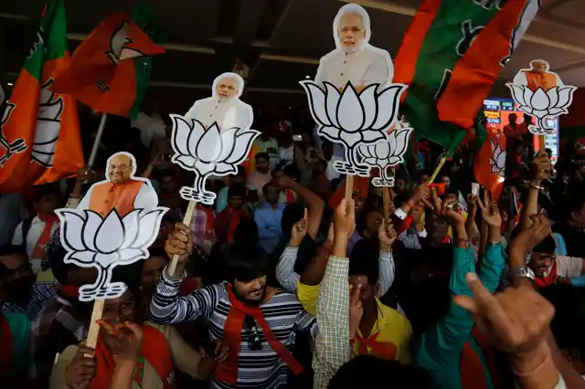 Supporters of BJP celebrate their party’s victory in Gujarat state Assembly elections in Gandhinagar.