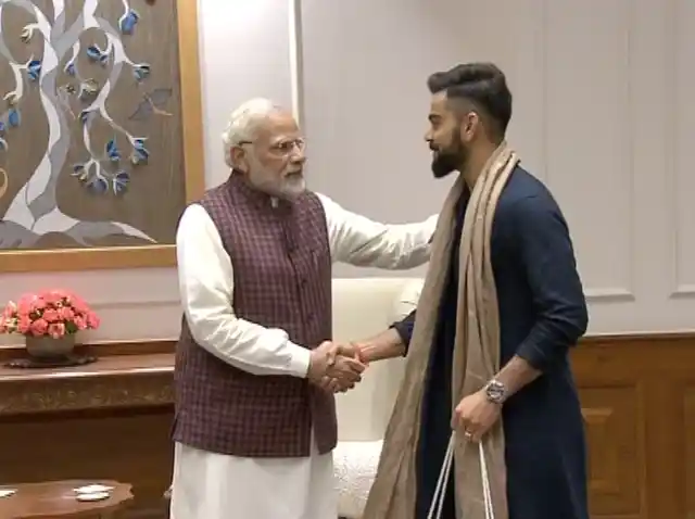 Modi greets Kohli.