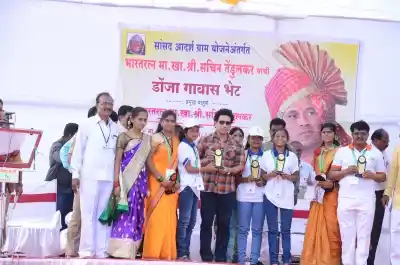 Osmanabad: Cricket legend Sachin Tendulkar felicitates children in Donja village in Osmanabad district of Maharashtra on Dec 19, 2017. The Rajya Sabha MP had come on his maiden trip to review the status of several project works in the village which he has