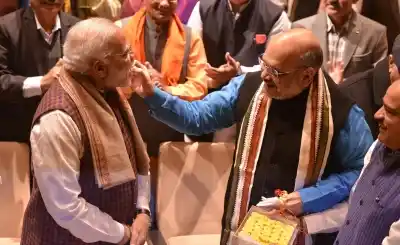 New Delhi: BJP chief Amit Shah greets Prime Minister Narendra Modi during BJP