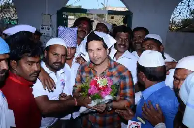 Osmanabad: Cricket legend Sachin Tendulkar being welcomed by villagers in Donja village in Osmanabad district of Maharashtra on Dec 19, 2017. The Rajya Sabha MP had come on his maiden trip to review the status of several project works in the village which he has