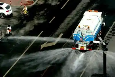 ZHENGZHOU, July 13, 2015 (Xinhua) -- A water cart sprays water on a street in Zhengzhou, capital of central China