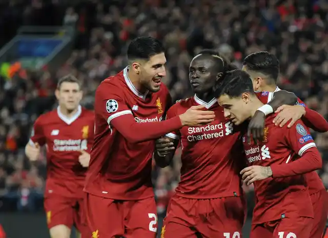 Liverpool’s Philippe Coutinho, right, celebrates with his teammates after scoring his side’s fifth goal.