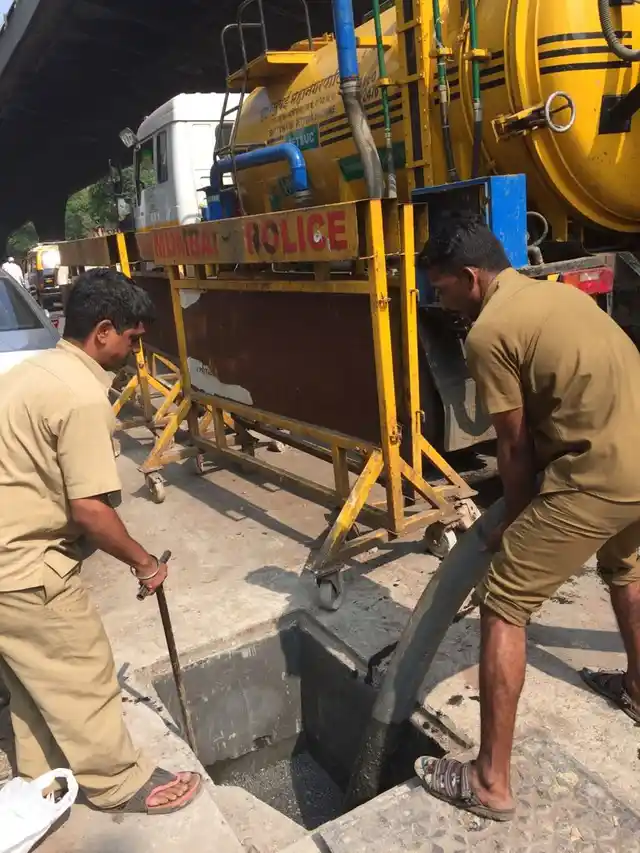 BMC storm drain cleaners work on a choked drain near Mazgaon.