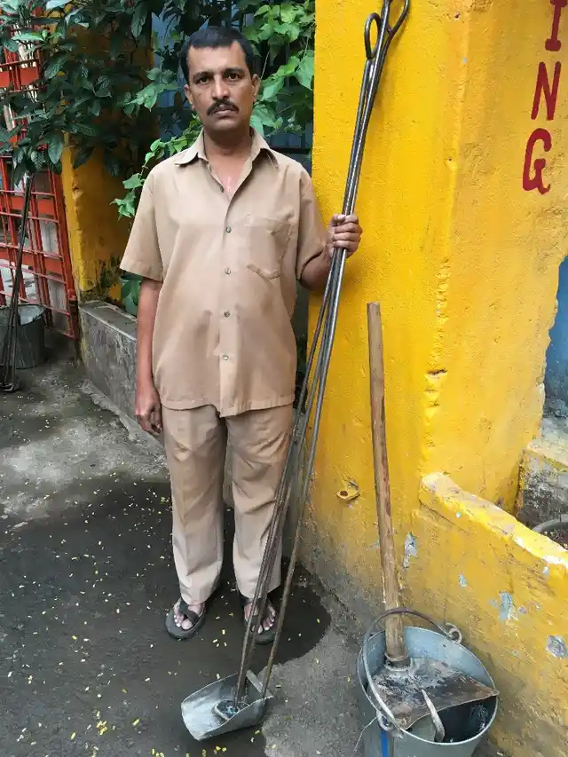 Santosh Patil gets ready with with his gear as he sets out for work from the BMC office near Charni Road.