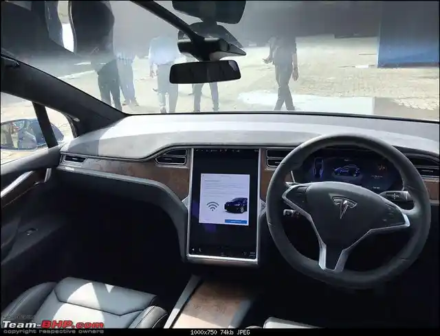 The Tesla Model X dashboard is dominated by a large central screen. 