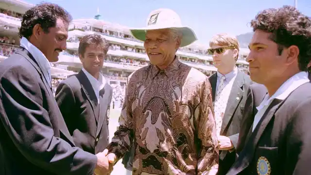 The then South African President Nelson Mandela (C) is introduced to Mohammad Azharuddin (L) by the then Indian captain Sachin Tendulkar (R) in 1997.