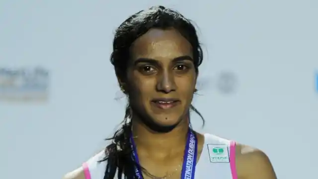 PV Sindhu poses with her silver medal at the Dubai World Super Series Finals.
