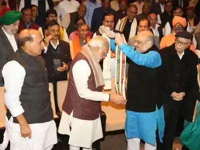 New Delhi: BJP president Amit Shah greets Prime Minister Narendra Modi during the BJP Parliamentary Party meeting at Parliament House in New Delhi on Dec. 20, 2017. Also seen Union Minister Rajnath Singh and other leaders. (Photo: Amlan Paliwal/IANS)