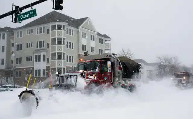 Trucks clear the streets during Storm Grayson at the Jersey shore in Sea Bright, New Jersey.