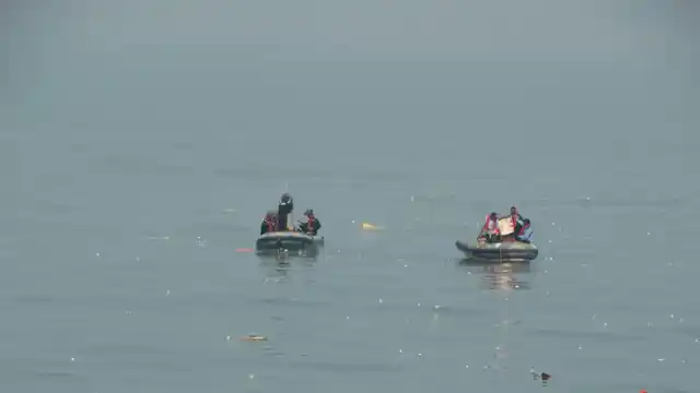 Debris and bodies being recovered from the crash site.