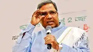 CM Siddaramaiah distributed free laptops to SC/ST college students with his photo pasted on the gadgets.