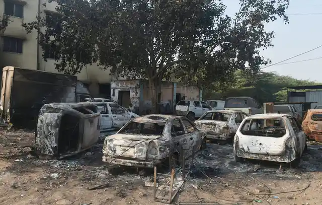 Charred vehicles following the violence during celebrations of 200th anniversary of the Battle of Bhima Koregaon, near Pune on Tuesday. 