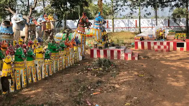 The temple at Alanganallur. A photographer pays obeisance with his camera.