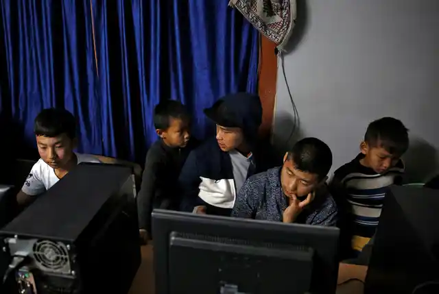 Youths gather in an internet gaming centre in the capital city of Thimphu, Bhutan, 11 December 2017.