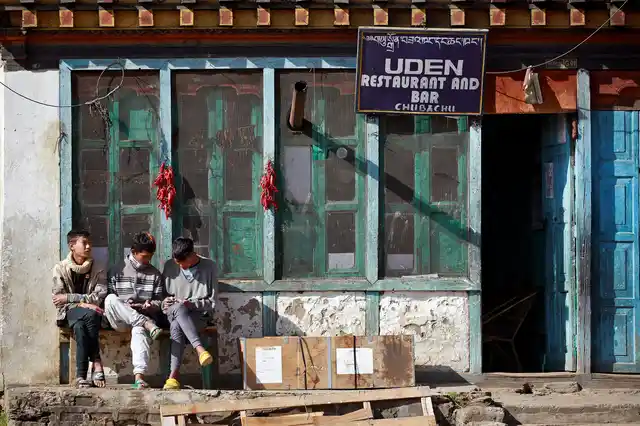 Youths sit outside a restaurant in the capital city of Thimphu, Bhutan, 16 December 2017.