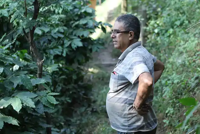 Ramesh Adhikari ponders the future of his coffee crop.