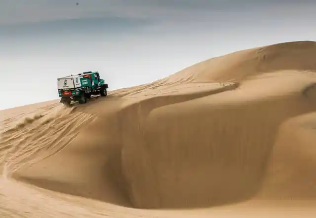 Iveco truck at the top of a dune.