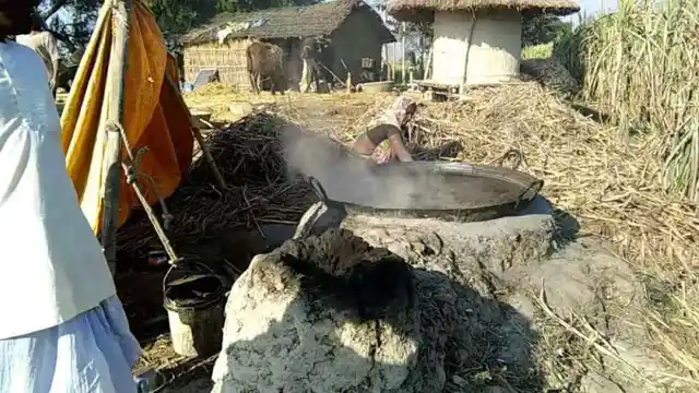 Rukhmani Devi boiling sugarcane juice to make <i>gur.</i>