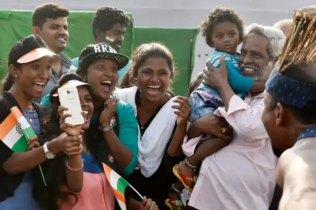 Spectators react as folk artists from Sidi Goma tribal group perform during the 69th Republic Day parade at Marina beach in Chennai, on Friday, 26 January 2018.
