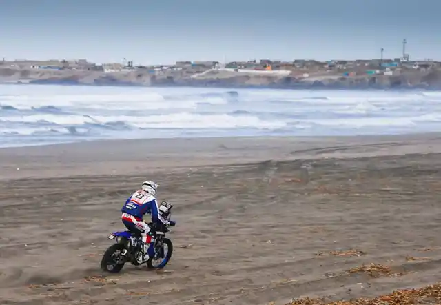 A biker at the beach during the fourth stage of Dakar.