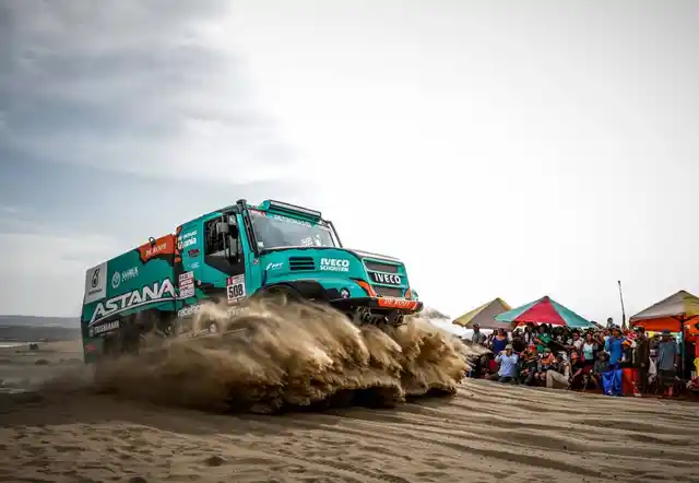 Spectators fascinated by just the massive size of the DAKAR Iveco Camion.