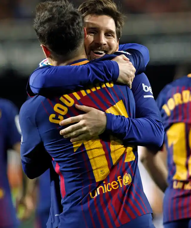 FC Barcelona’s Coutinho is congratulated by teammate FC Barcelona’s Lionel Messi after scoring a goal against Valencia during the Spanish Copa del Rey, semifinal, second leg, soccer match between FC Barcelona and Valencia at the Mestalla stadium in Valencia, Spain, Thursday Feb. 8, 2018. 