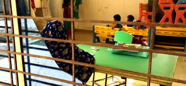 Rekha watches over the children to keep them away from broken glass at the lone aanganwadi in Jayapur village in Varanasi.