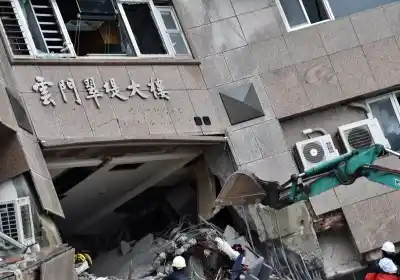 TAIPEI, Feb. 8, 2018 (Xinhua) -- An excavator is seen at the damaged Yun Men Tusi Ti building in Hualien, southeast China
