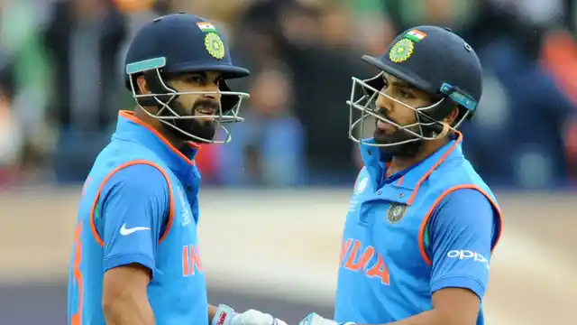 Virat Kohli and Rohit Sharma have a chat during a match.