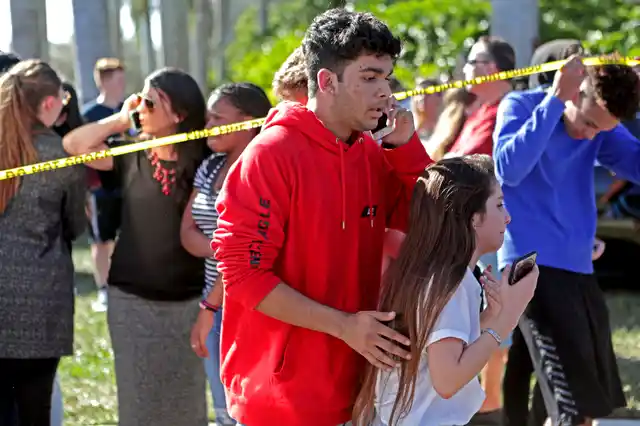 Students released from a lockdown are overcome with emotion following following a shooting at Marjory Stoneman Douglas High School in Florida on 14 February 2018.
