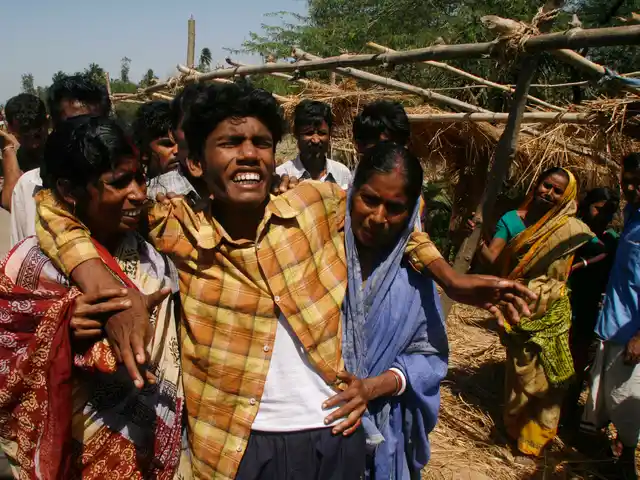 16 March 2007: Soumya Kanti Jana,(C) whose mother Supriya Jana was killed by police on Wednesday, is consoled by relatives in Sonachura, a small village in Nandigram. 