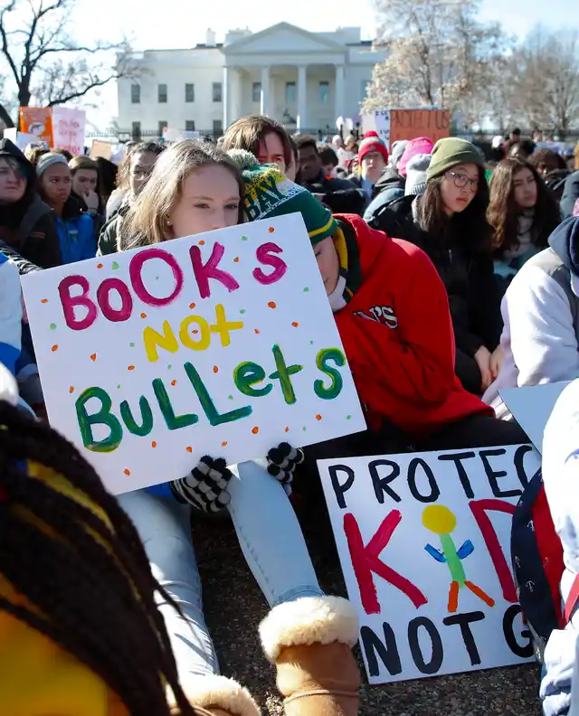 Students sit in silence as they rally in front of the White House in Washington DC.