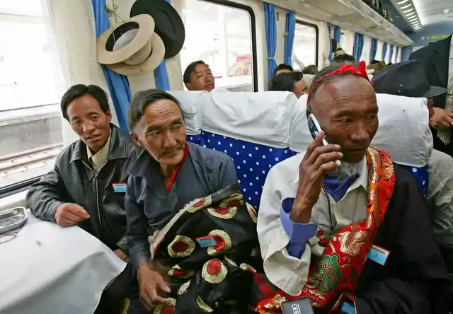 Passengers sit on board the first train at Lhasa railway station as it heads for Lanzhou in Gansu province 1 July 2006.
