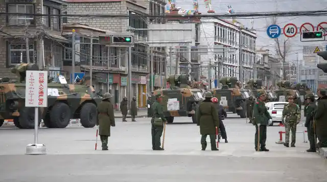 A convoy of armoured personnel carriers (APC) travel through the streets of Lhasa, Tibet March 15, 2008. 