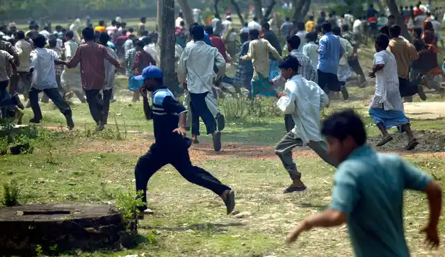 15 March 2007: Villagers run as police fire teargas shells in Nandigram. Baton-wielding police fired tear gas and beat dozens of villagers in West Bengal, who were protesting the killing of at least 14 people in a land dispute.