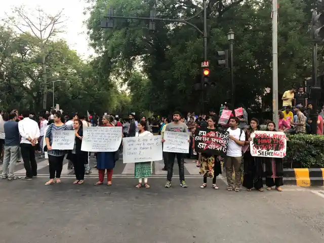 Protesters hold placards in solidarity.
