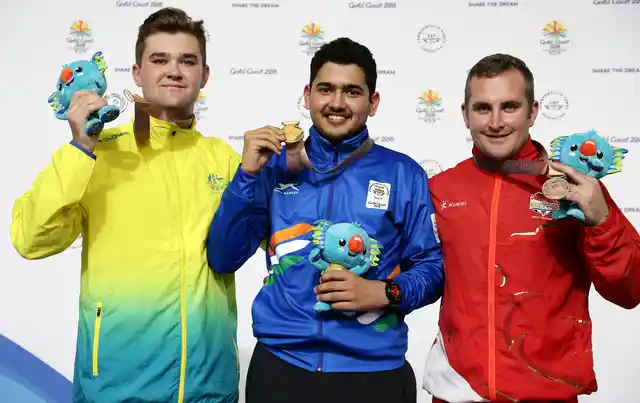 Sergei Evglevski of Australia, left, silver medal, Anish of India, center, gold medal, and Sam Gown of England, right, bronze medalist.