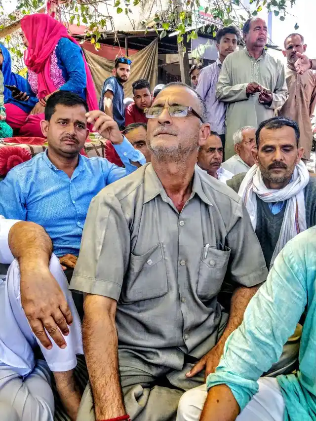Bagmal Khajuria listens as Kant Kumar, the vice president of Hindu Ekta Manch, speaks.