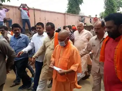 Kushinagar (Uttar Pradesh): Uttar Pradesh Chief Minister Yogi Adityanath arrives at the site of accident where thirteen school children were killed and six others seriously injured when a train hit their van at an unmanned railway crossing in Uttar Pradesh