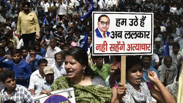 Members of the Dalit community raise slogans during the Bharat Bandh against the alleged dilution of SC/ST Act in New Delhi, on 2 April.