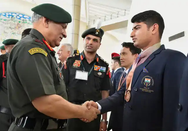 Army chief Bipin Rawat greets Indian Army shooter Om Prakash (R), who won double bronze medal in the Commonwealth Games 2018, at Manekshaw Centre in New Delhi on 18 April.