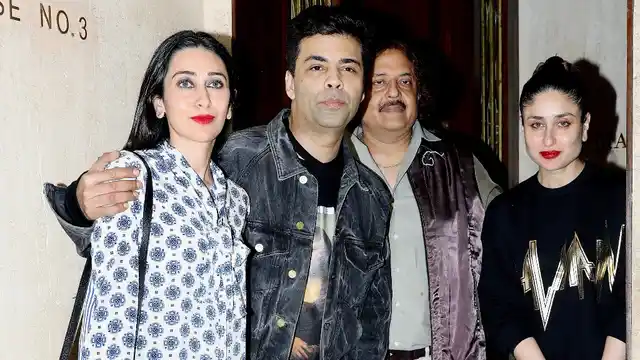 Kareena Kapoor, Karisma Kapoor and Karan Johar pose while exiting Manish Malhotra’s house. 
