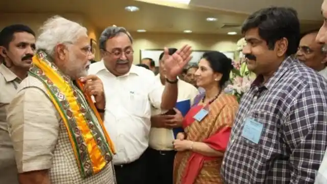 Amit Bhatnagar (right) with PM Narendra Modi (left) and BJP leader Saurabh Patel (centre). 