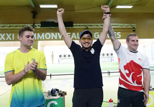 Sergei Evglevski of Australia, left, silver medal, Anish of India, center, gold medal, and Sam Gowin of England, right, bronze medal, during the men’s 25m Rapid Fire Pistol final at the Belmont Shooting Centre during the 2018 Commonwealth Games