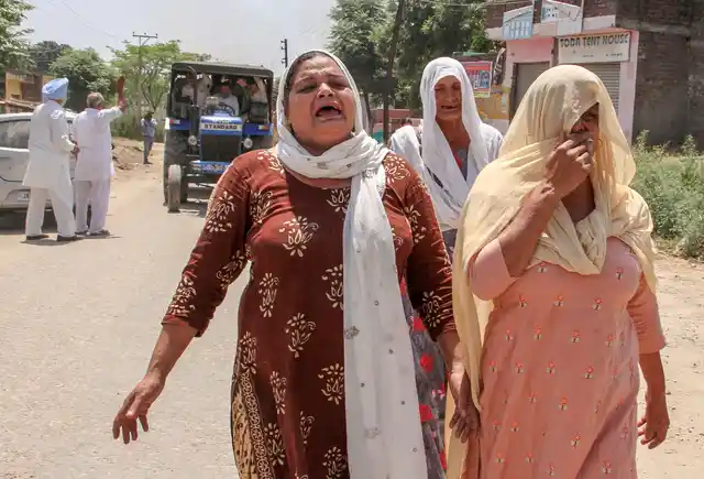 Relatives of Shammo Devi , who was killed in Pakistani shelling, mourn during his funeral at Baingalrh village in Samba, about 52 kms from Jammu, on Wednesday.