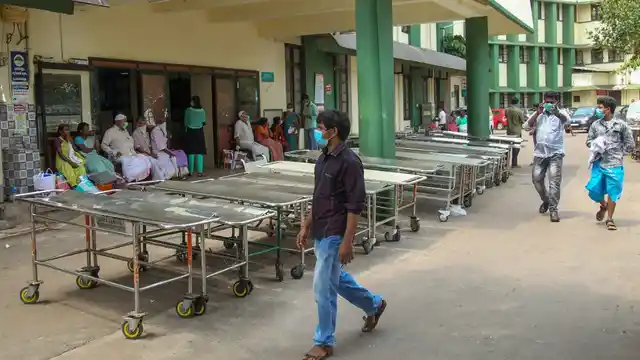 Patients wear safety masks as a precautionary measure after the Nipah virus outbreak, outside the medical college, in Kozhikode.