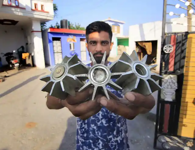 A villager shows tails of mortar shells, claimed to be fired from the Pakistani side, along the international border at Gopper Basti in Jammu.