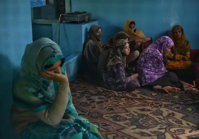 Relatives sitting tormented during Amir Hameed Lone’s funeral.