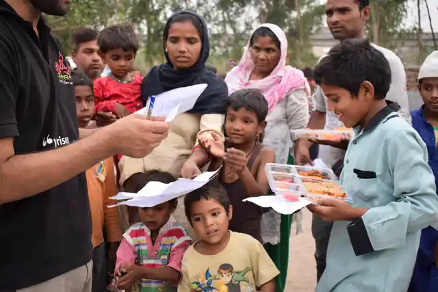 Volunteers hand out food packets.